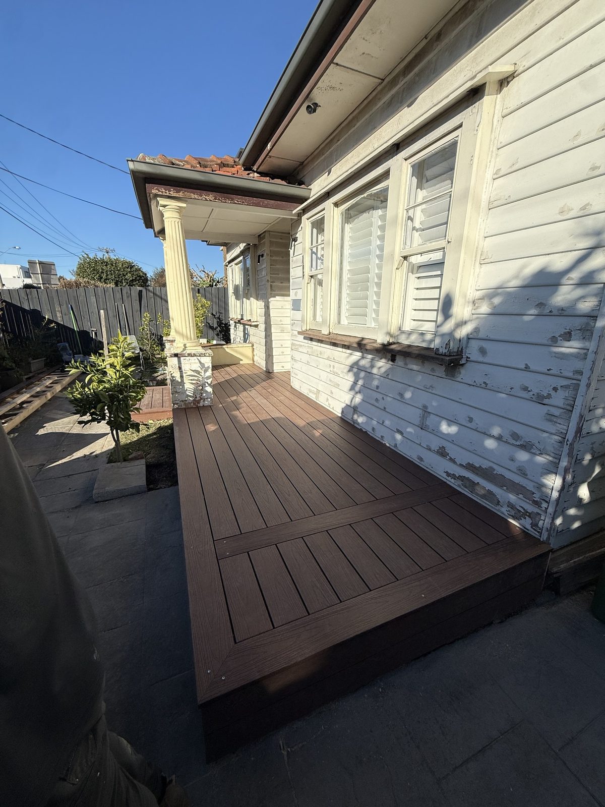 The same verandah finished in dark composite decking