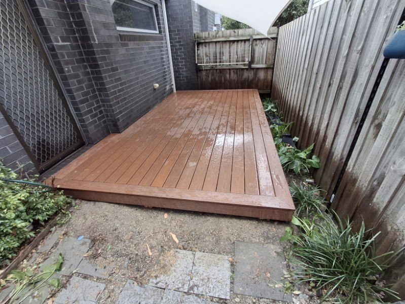 Composite decking laid over a former paved courtyard